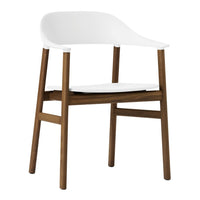 White minimalist chair with smooth curves and warm brown wooden legs, perfect for modern decor.