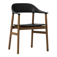 Black modern chair with a sleek design and light wooden legs, featuring smooth finishes and minimalistic styles.