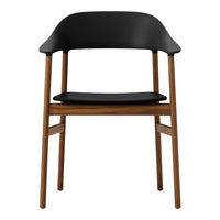 Modern chair featuring a sleek black seat and backrest with natural wood legs for a stylish contrast.