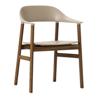 Beige plastic chair with a smooth finish and natural wood legs, featuring a minimalist design and simple shapes.