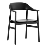 Black chair with smooth, modern design and sleek finish, featuring minimalist curves and no visible patterns.