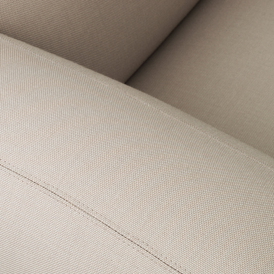 Beige upholstery with a subtle texture and stitched detail, ideal for modern home decor.