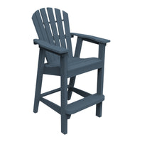 Navy blue Adirondack chair with slatted back and wide armrests, perfect for outdoor relaxation.