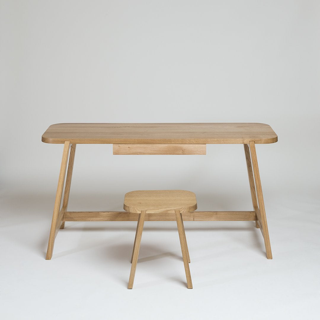 Light wood table and stool set with smooth, minimalist design and natural finish, perfect for modern decor.