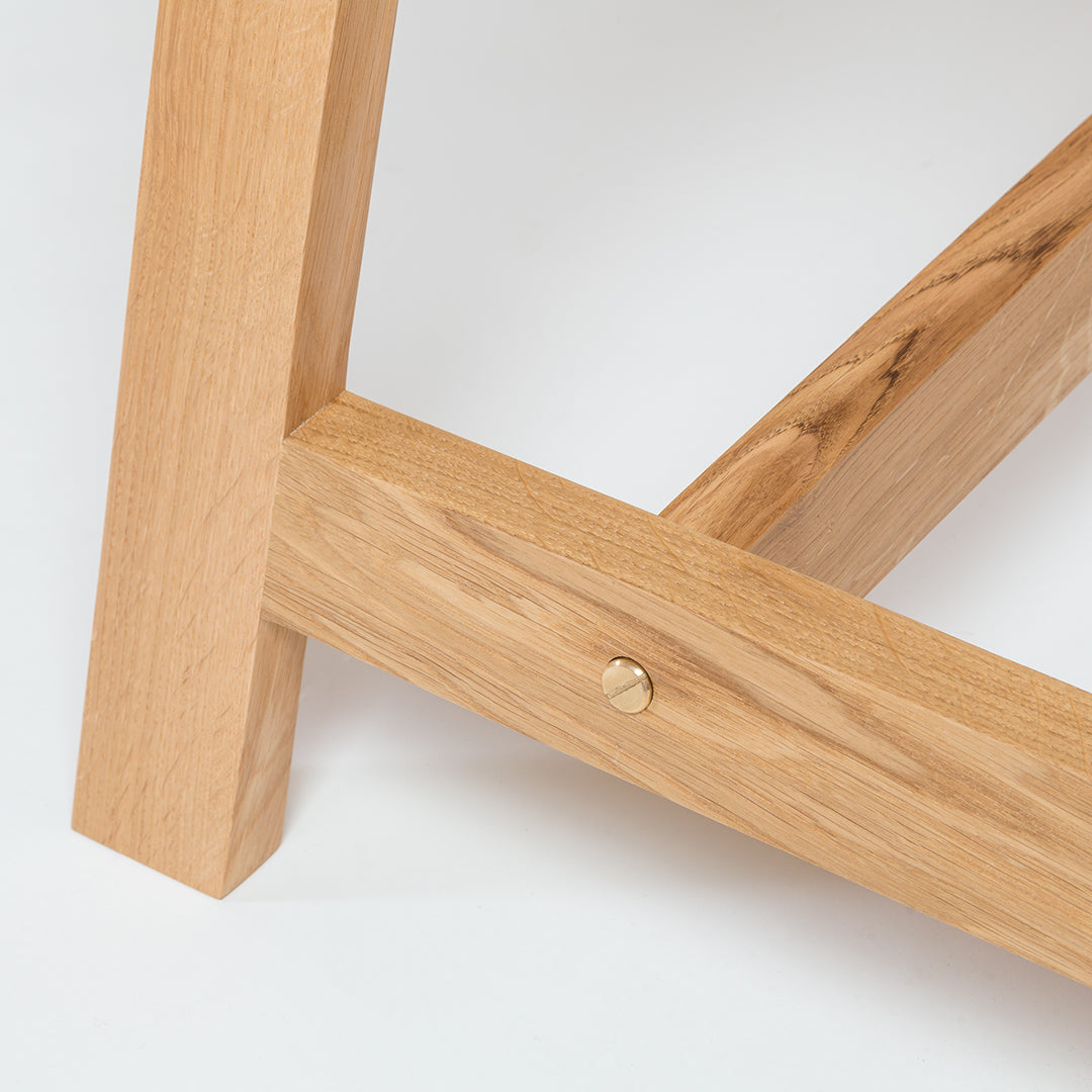 Natural oak wood grain with smooth finish and brushed brass accent, showcasing elegant minimalist design.