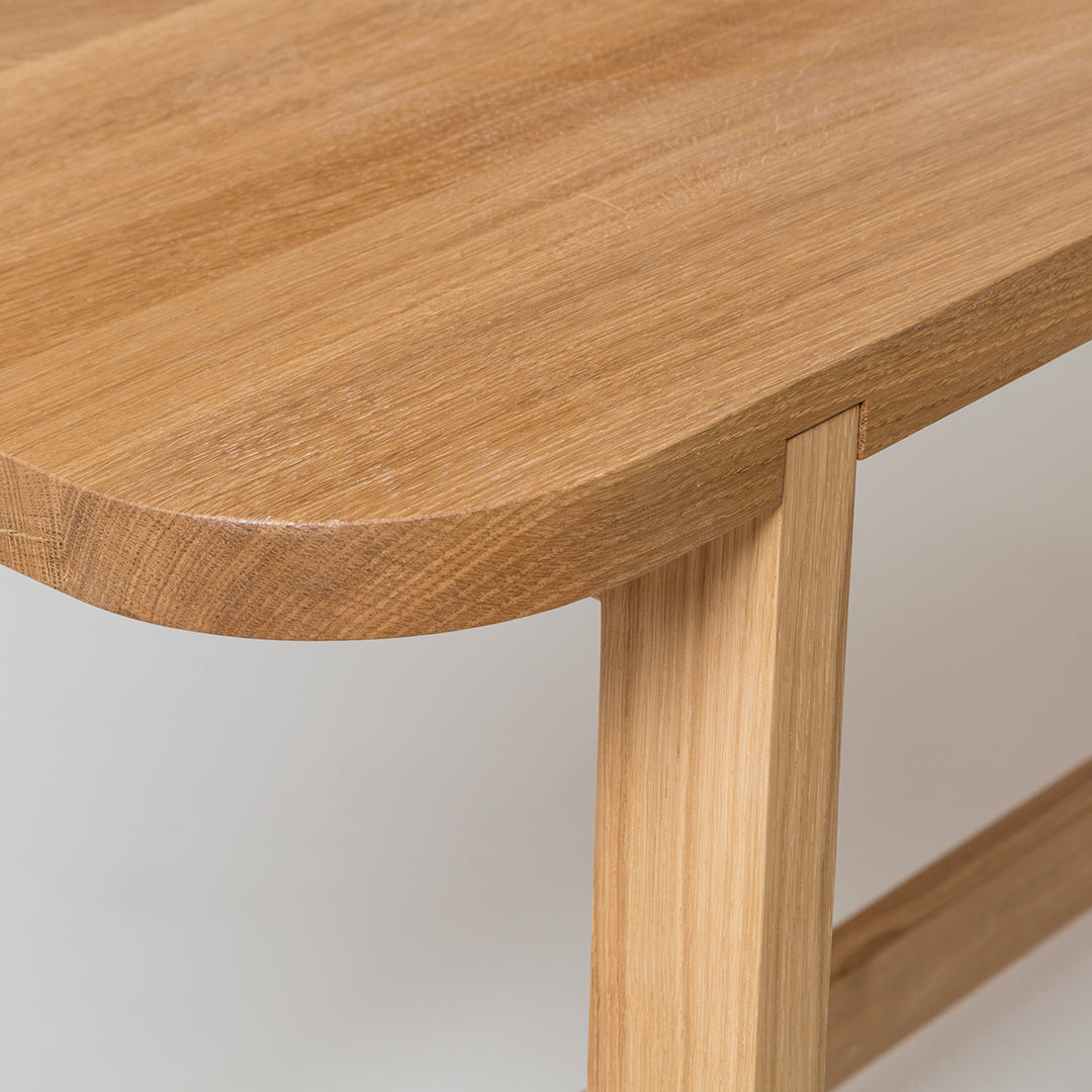 Light wood table with smooth, rounded edges and natural grain pattern, showcasing warm beige and brown tones.