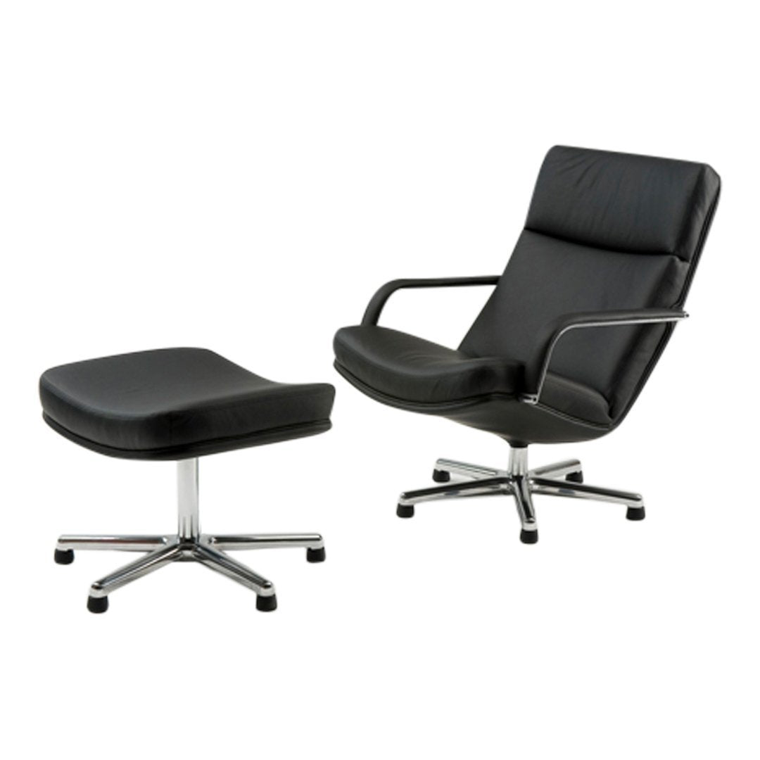 Black leather lounge chair with ottoman, featuring a smooth finish and sleek chrome accents. Perfect for modern interiors.