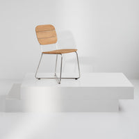 Modern chair featuring a natural wood seat and sleek metal frame, set against a minimalist white background.
