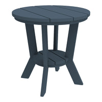 Round navy blue accent table with slatted top and cross legs, perfect for outdoor or indoor use.
