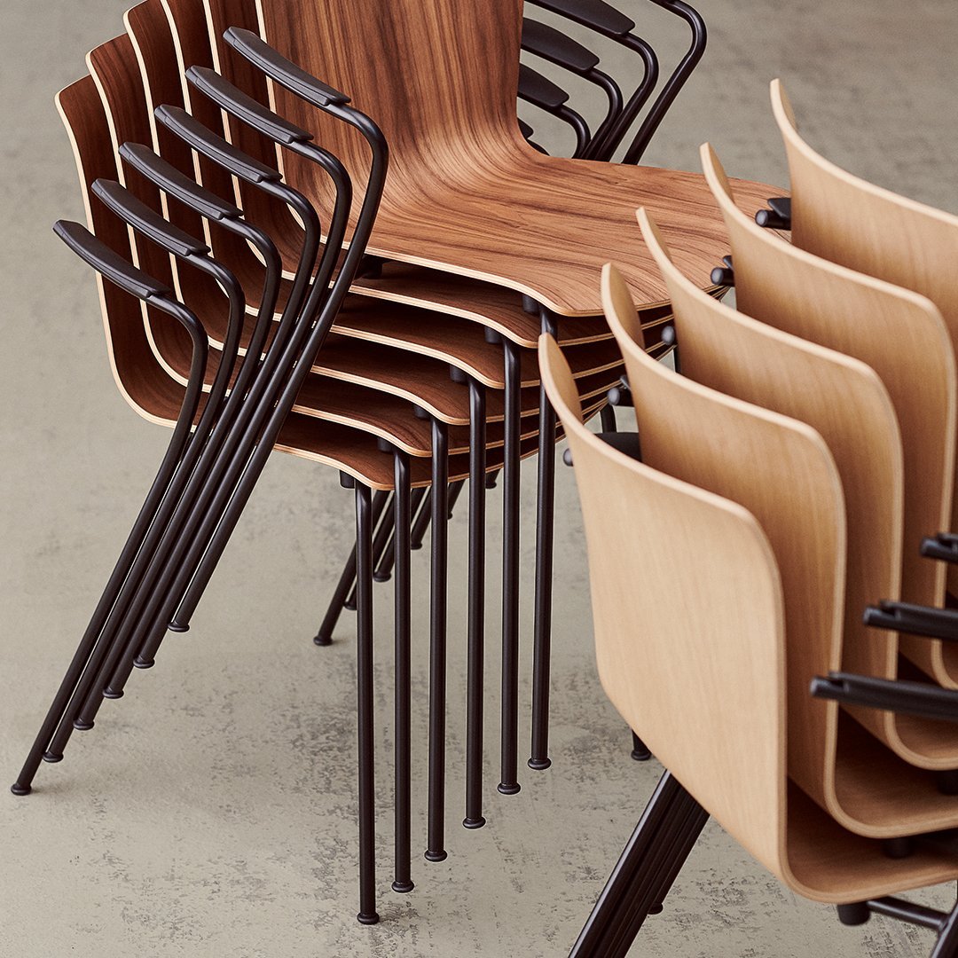 Stacked chairs featuring a mix of warm wood grain finishes and sleek black metal frames, creating a modern, minimalist look.