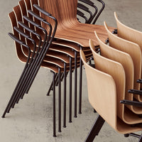 Stacked chairs featuring a mix of warm wood grain finishes and sleek black metal frames, creating a modern, minimalist look.