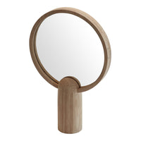Wooden hand mirror with a round frame, showcasing a natural light beige finish and smooth, minimalist design.