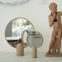 Wooden rounded mirrors with natural wood finish, reflecting light and featuring soft, organic shapes.