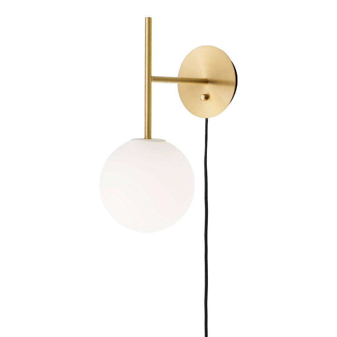 Sleek brass wall lamp with a round frosted glass globe and a stylish black wire, perfect for modern decor.