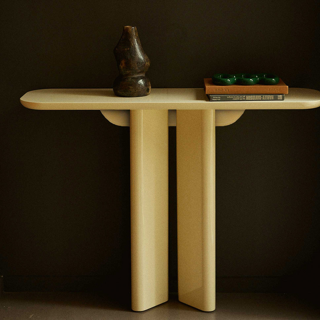 Beige modern console table with a smooth surface, complemented by dark accents and minimalist design.