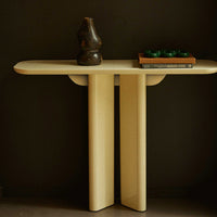 Beige modern console table with a smooth surface, complemented by dark accents and minimalist design.