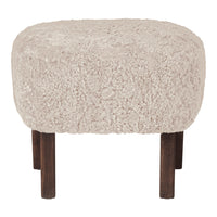 Textured beige ottoman with a fluffy surface and dark wooden legs, perfect for cozy decor.