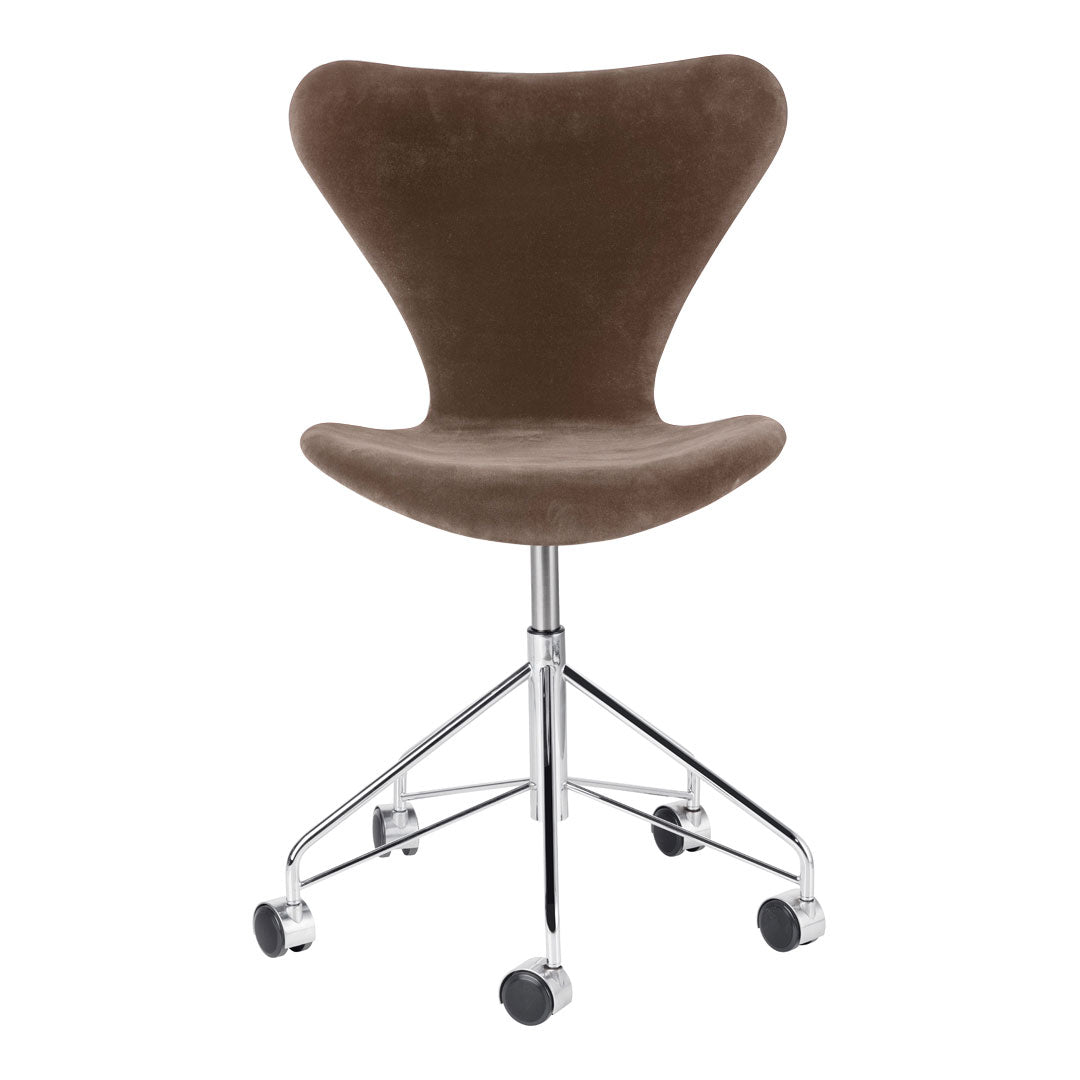 Brown velvet swivel chair with a sleek chrome base, featuring a minimalist and modern design.