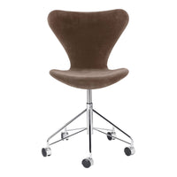Brown velvet swivel chair with a sleek chrome base, featuring a minimalist and modern design.