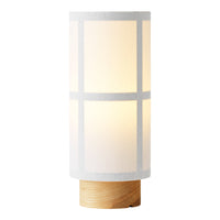 White cylindrical lamp with a geometric pattern and a wood base, providing a warm, soft glow.