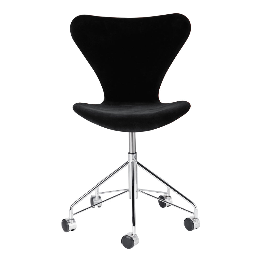 Black velvet chair with a sleek, modern design and chrome base on rolling casters.