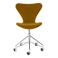 "Velvet mustard yellow chair with a sleek chrome base and rolling wheels, perfect for modern office decor."