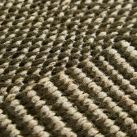 Green and beige woven rug featuring a textured diamond pattern, ideal for modern home decor.