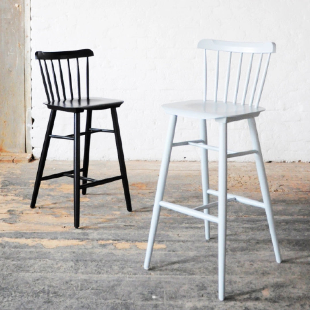 Black and white bar stools with classic spindle design, featuring a smooth matte finish. Perfect for modern interiors.