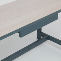 Light wood top with a smooth finish and dark blue metal legs. Modern design with a minimalist aesthetic.