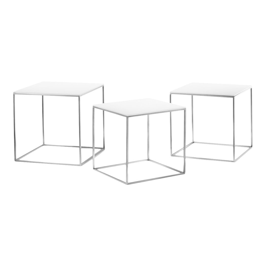 Set of three modern geometric side tables with white tops and silver metal frames, featuring sleek, minimalist design.