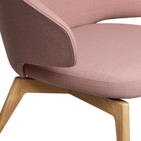 Soft pink fabric chair with a contrasting brown accent and natural wood legs, adding a modern touch to any space.