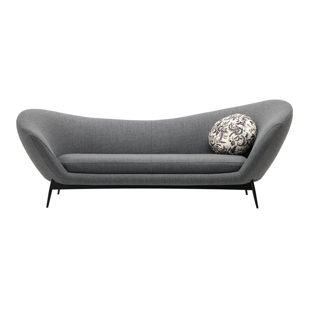 Stylish grey sofa with a unique curved shape and a decorative patterned pillow for added contrast.