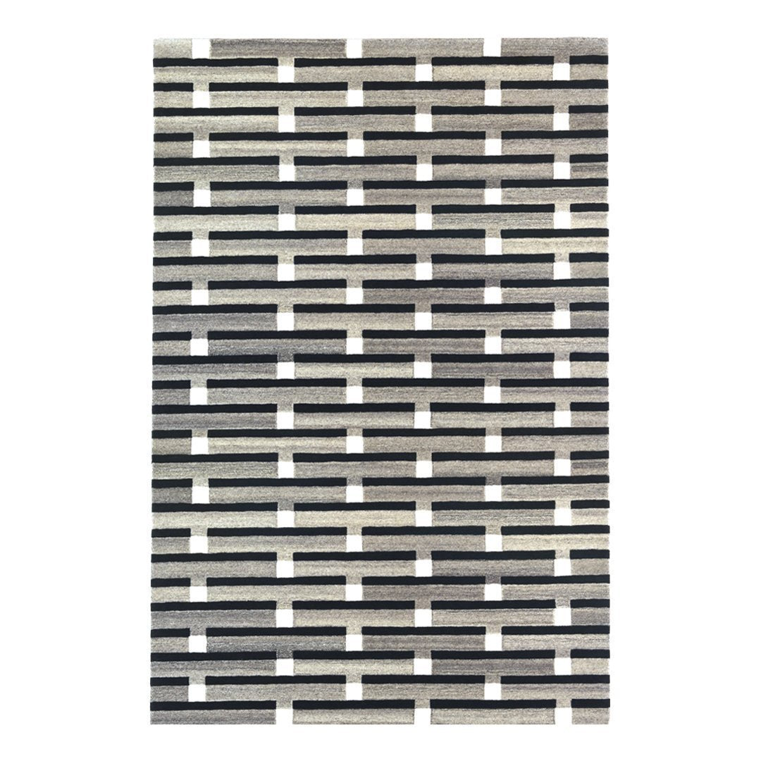 Black and white patterned rug featuring a geometric, grid-like design with alternating stripes.
