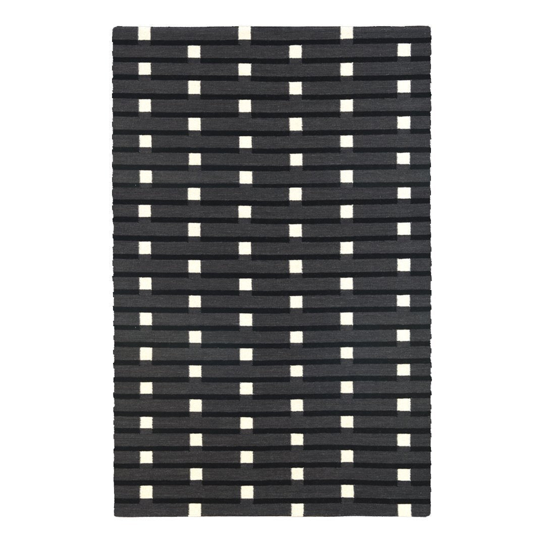 Black and white patterned rug featuring alternating rows of thick lines and squares for a modern look.