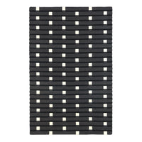 Black and white patterned rug featuring alternating rows of thick lines and squares for a modern look.