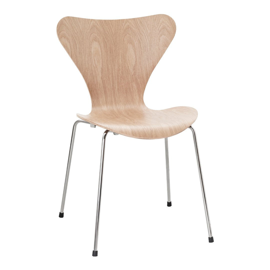 Light wood chair with a sleek, curved design and chrome legs, showcasing a natural finish and minimalist aesthetic.
