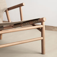 Natural wood tones with earthy beige fabric and subtle gold accents in a minimalist design. Perfect for modern decor.