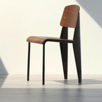 "Modern wooden chair with a rich brown seat and sleek black metal legs, showcasing minimalist style."