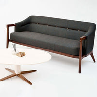 Stylish gray fabric sofa with wooden legs and button detailing, paired with a modern white coffee table.