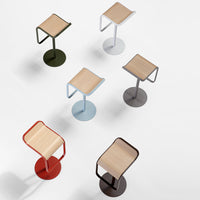"Colorful bar stools in various hues: red, green, blue, and brown with natural wood tops and modern geometric patterns."