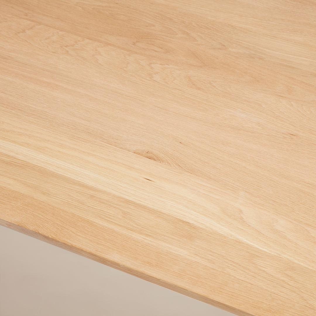 Light natural wood tabletop with smooth, subtle grain patterns, showcasing a warm, minimalistic design.