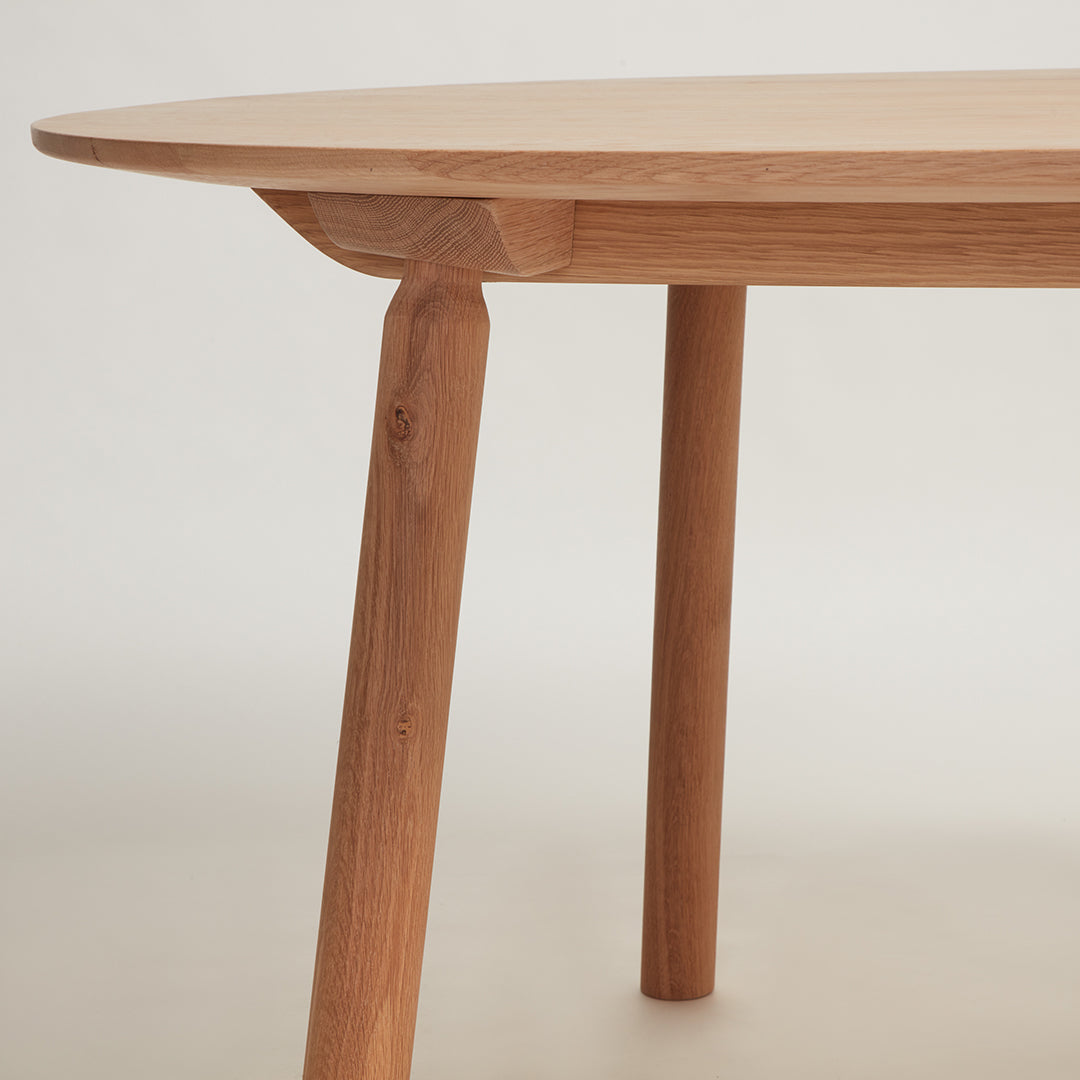 Natural wood table, featuring a smooth light beige top and warm wooden legs, showcasing a minimalist aesthetic.