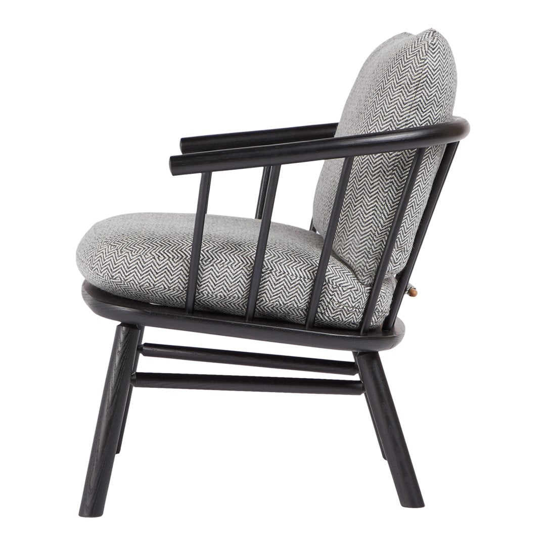 Side view of a modern chair with a black wooden frame and a textured gray upholstery. Stylish and contemporary design.