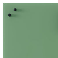 Green surface with a matte finish and two black knobs, creating a simple, modern aesthetic.