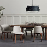 Modern dining set featuring neutral gray and beige chairs with warm wood tones and a textured black pendant light.