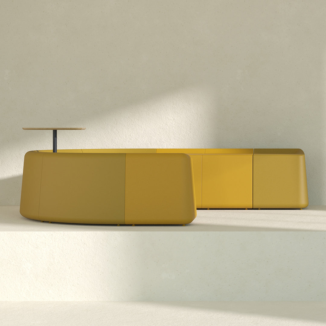 Modern curvy yellow sofa with a smooth finish, featuring a sleek design and subtle color variations.
