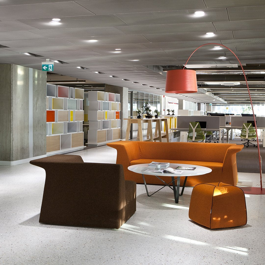 "Modern orange and brown furniture with a geometric design in a stylish, brightly lit interior space."