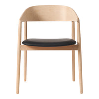 Minimalist chair featuring light wood frame and sleek black seat. Modern design with natural colors and smooth finishes.
