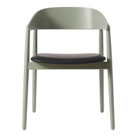 Minimalist chair in soft green frame with a sleek black seat, perfect for modern decor.
