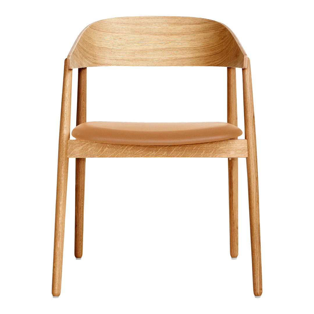 Light wood chair with a smooth, tan leather seat, showcasing a minimalist design and natural textures.